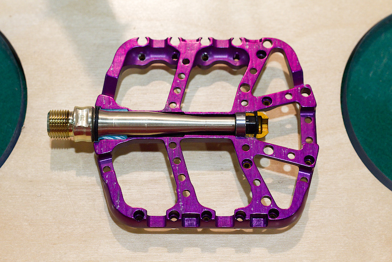 Tyler must have locked himself in his one man, Montana shop over the last few months because he has yet more updates to share. The much sought after PreRunner pedal goes from a dual bushing design to a freer spinning sealed bearing at the axle's outer end, combined with a bushing at the crank end. The axle itself is also larger for '11, as is the thin, but wider, pedal body. The area around the pedal pins gets a bit of extra material added for better support as well. Even though it still bears the same name, it looks to me like this is nearly an entirely new pedal!