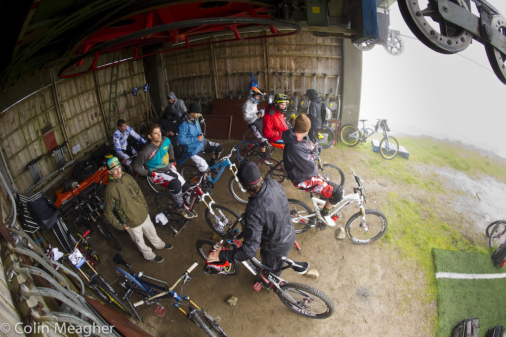 Warming up out of the rain meant using an old lift shack. With so many racers needing a place to get spun up competition for a sheltered spot was fierce. Some teams staked out space during the woment s race.
